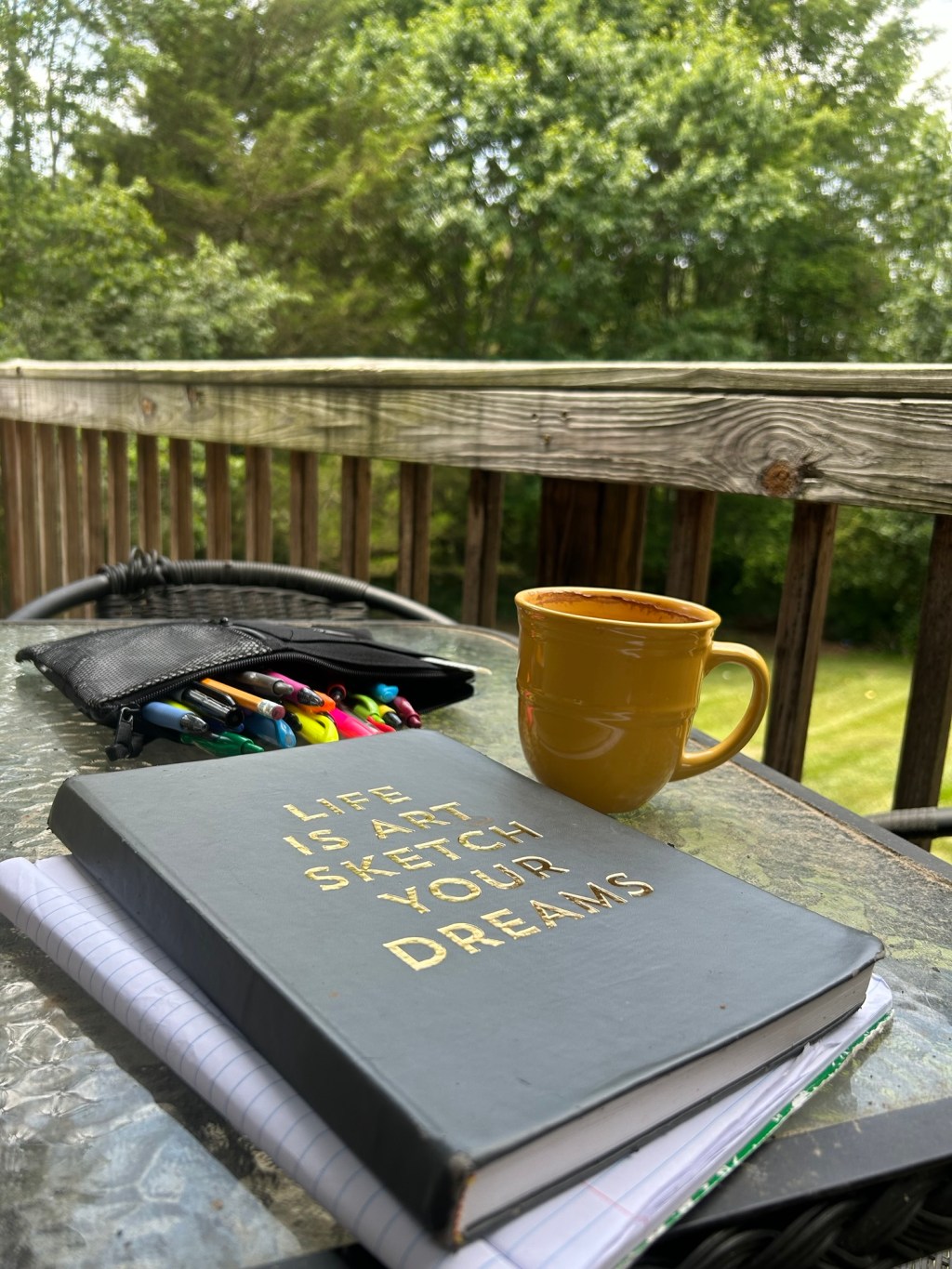 tBLE ON THE PORCH WITH A CUP OF HOT CHOCOLATE AND A SKETCH BOOK